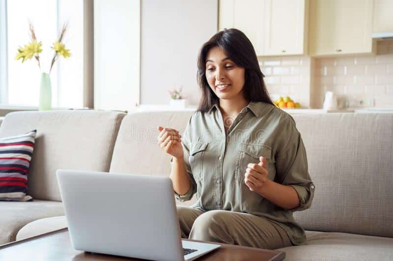 indian-woman-online-teacher-talking-video-call-using-laptop-home-young-adult-distance-tutor-job-applicant-conferenc